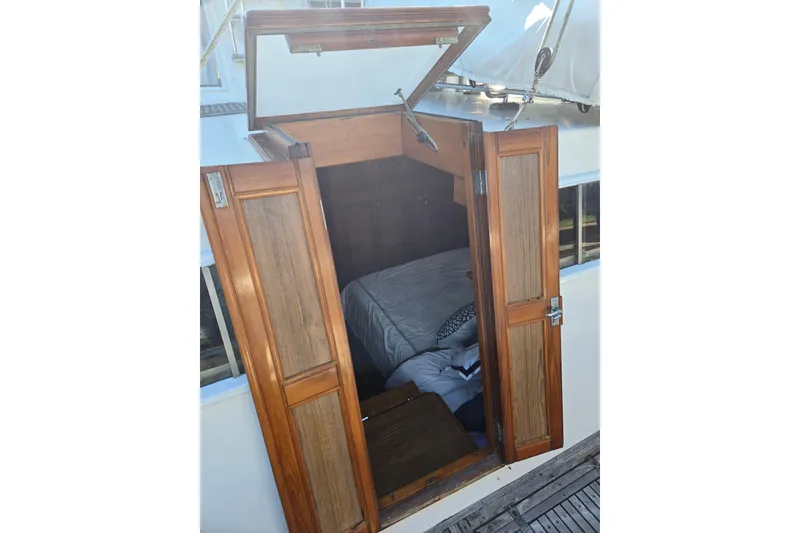 Slide: The Image of Wooden cabin entrance of 1992 Grand Banks 46 Classic yacht, showing interior bedding. - 53