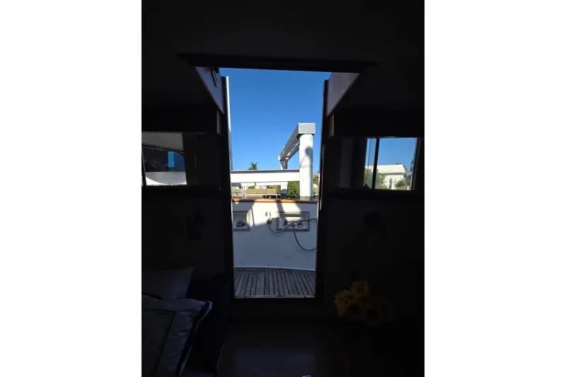 Slide: The Image of Interior view from a 1992 Grand Banks 46 Classic yacht, showing the deck and blue sky. - 54