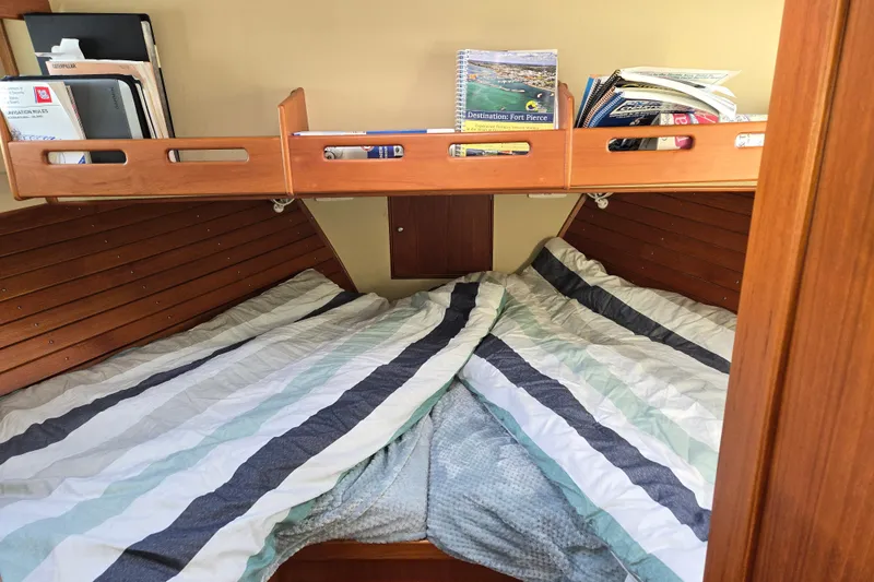 Slide: The Image of Cozy cabin interior of 1992 Grand Banks 46 Classic yacht with striped bedding and wooden shelves. - 55
