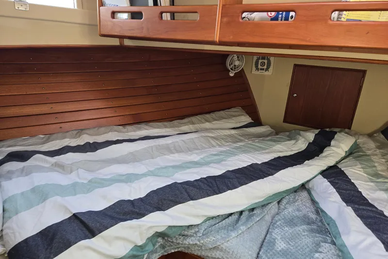 Slide: The Image of Cozy cabin interior of 1992 Grand Banks 46 Classic with striped bedding. - 56