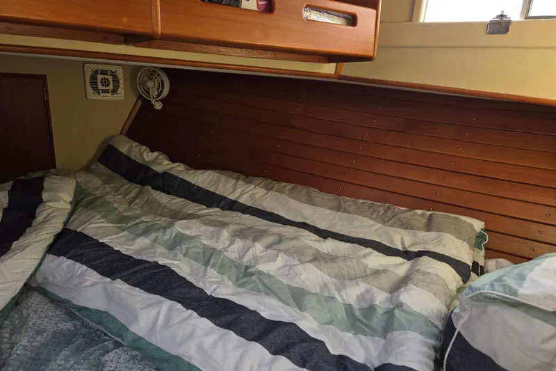 Slide: The Image of Cozy cabin interior of 1992 Grand Banks 46 Classic with striped bedding. - 57
