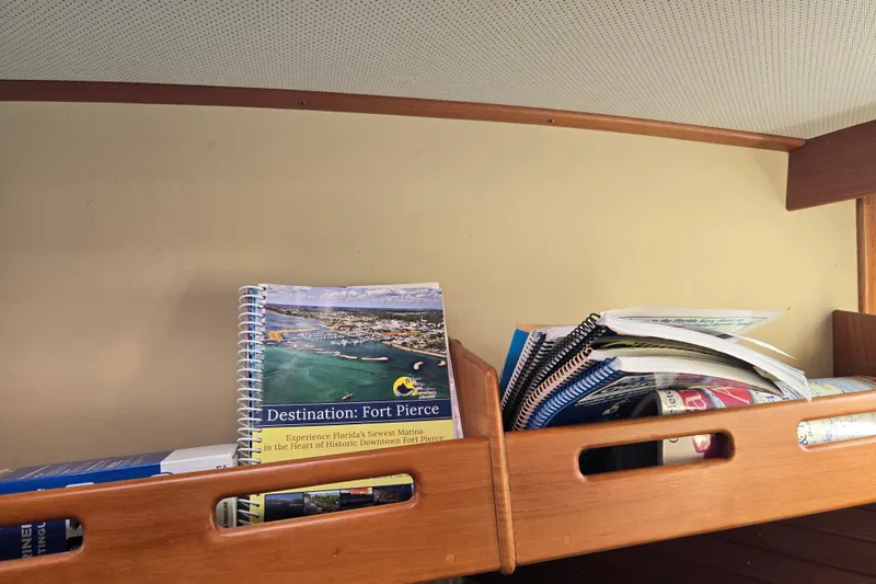 Slide: The Image of Books and guides on a wooden shelf inside a 1992 Grand Banks 46 Classic yacht. - 59