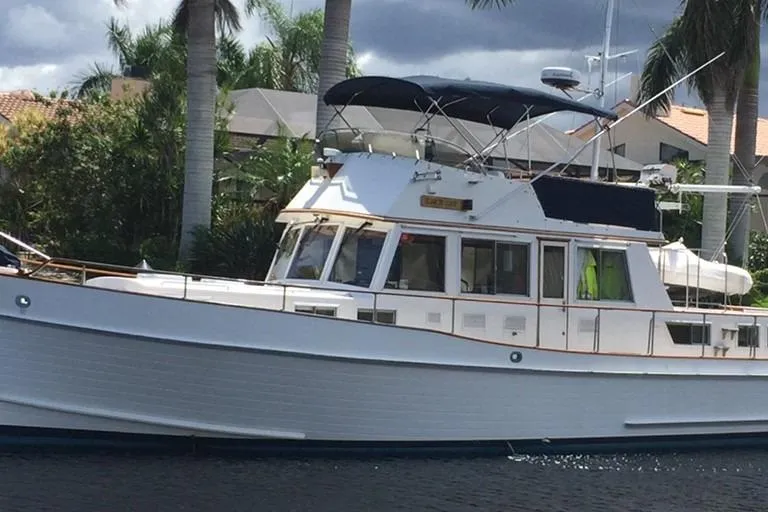 Slide: The Image of 1992 Grand Banks 46 Classic yacht docked near palm trees. - 66