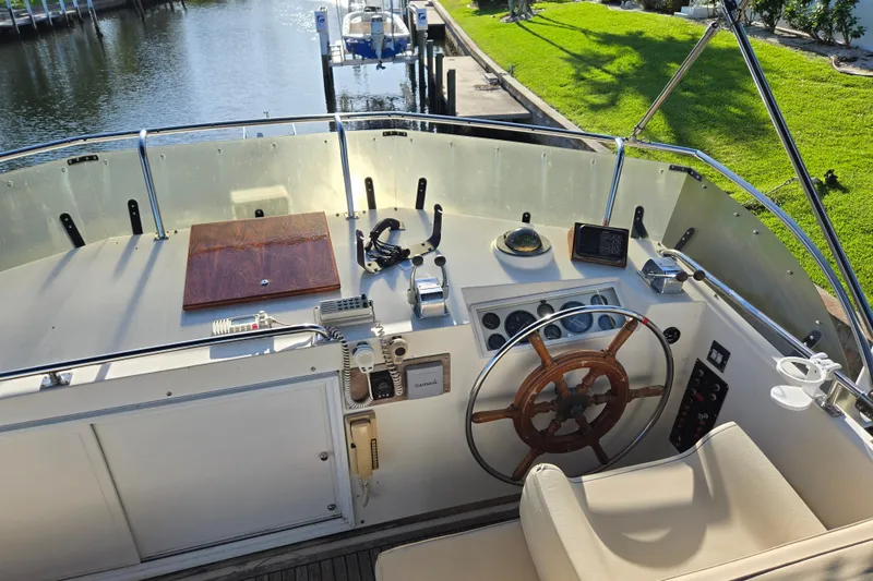 Slide: The Image of Helm of 1992 Grand Banks 46 Classic yacht with wooden wheel and navigation instruments. - 68