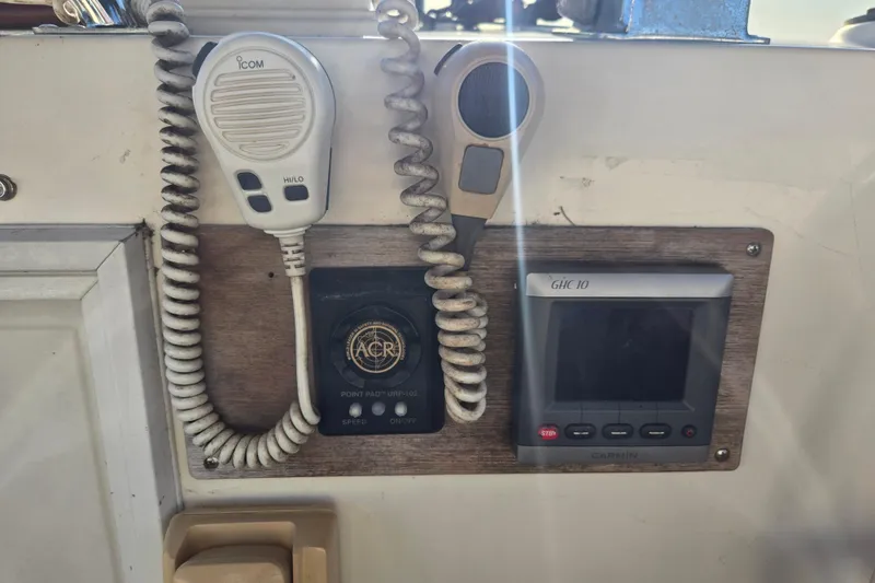 Slide: The Image of Control panel of a 1992 Grand Banks 46 Classic with communication devices and Garmin display. - 75