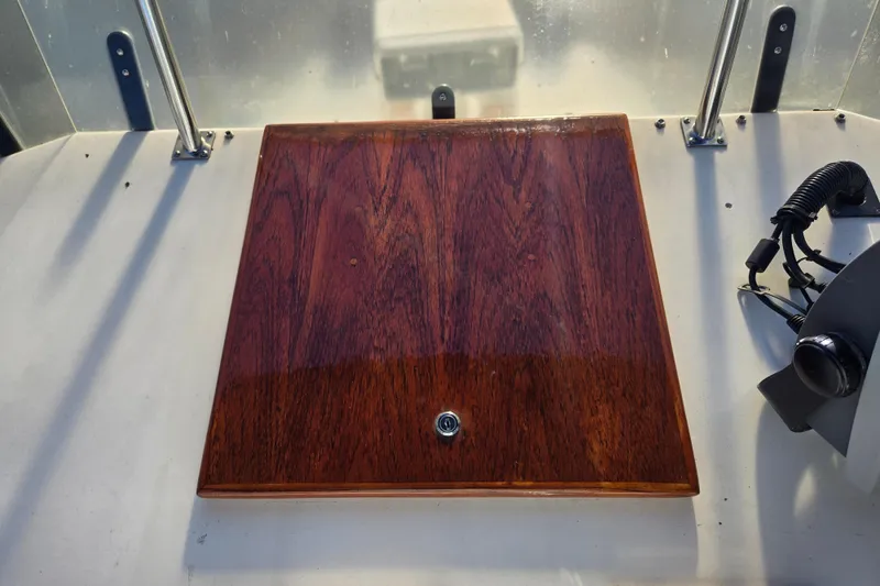 Slide: The Image of Wooden hatch on 1992 Grand Banks 46 Classic boat deck, with metal railing and control panel. - 76