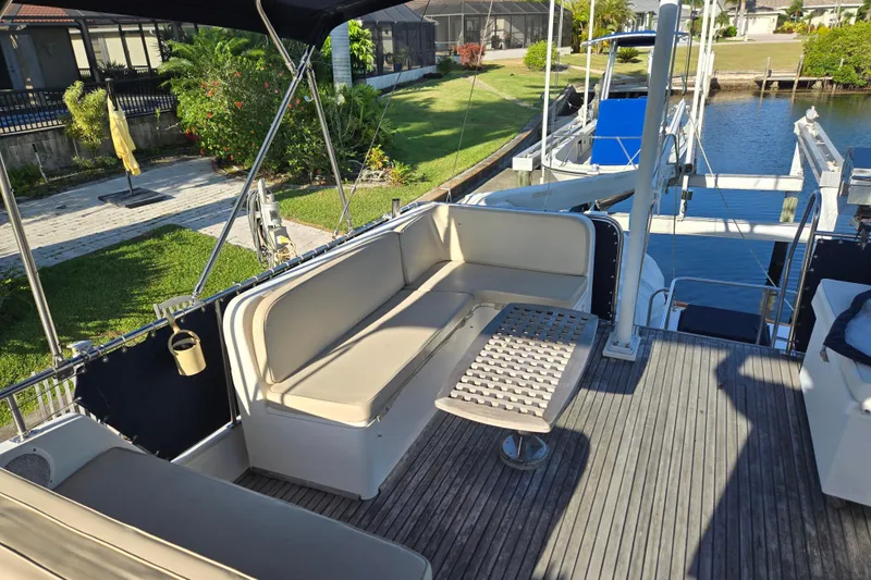Slide: The Image of Deck seating area on a 1992 Grand Banks 46 Classic yacht by the water. - 80