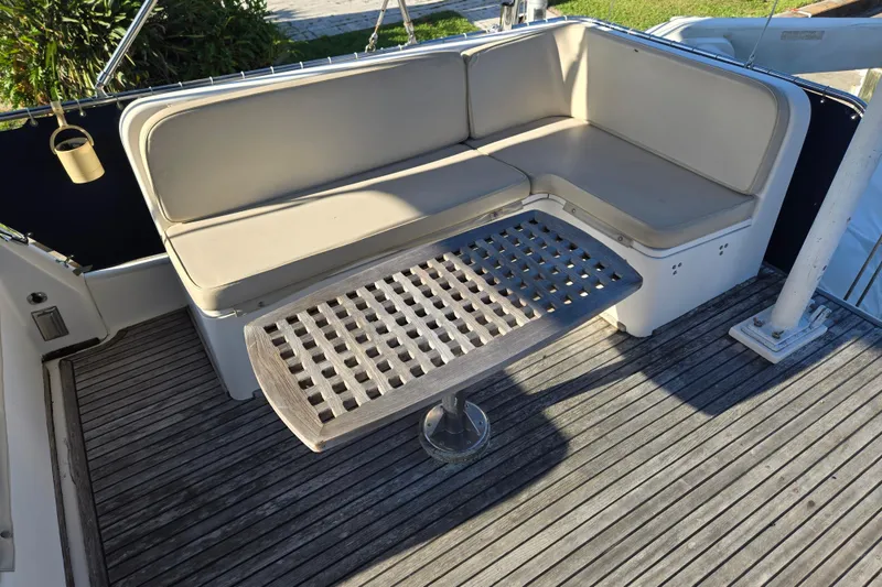 Slide: The Image of Deck seating area on a 1992 Grand Banks 46 Classic yacht with wooden table. - 81