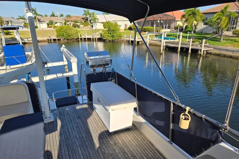 Slide: The Image of Deck view of 1992 Grand Banks 46 Classic yacht docked by a serene canal. - 82