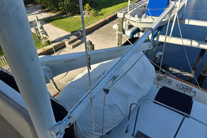 Slide: The Image of 1992 Grand Banks 46 Classic yacht deck with covered equipment and dock view. - 85