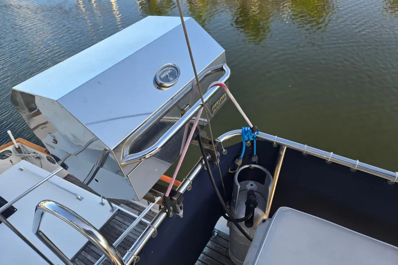 Slide: The Image of Stainless steel grill on 1992 Grand Banks 46 Classic yacht, overlooking calm water. - 88