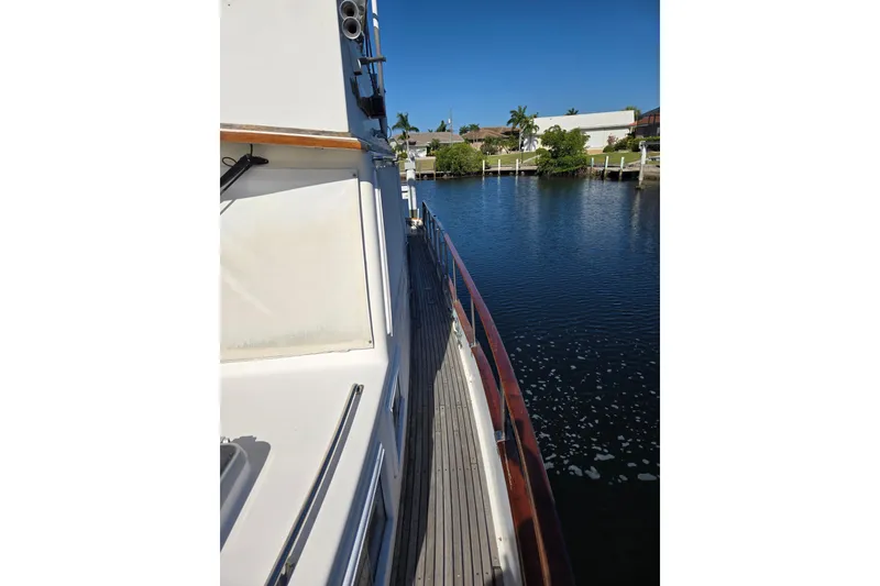 Slide: The Image of Side view of a 1992 Grand Banks 46 Classic yacht on calm water. - 90