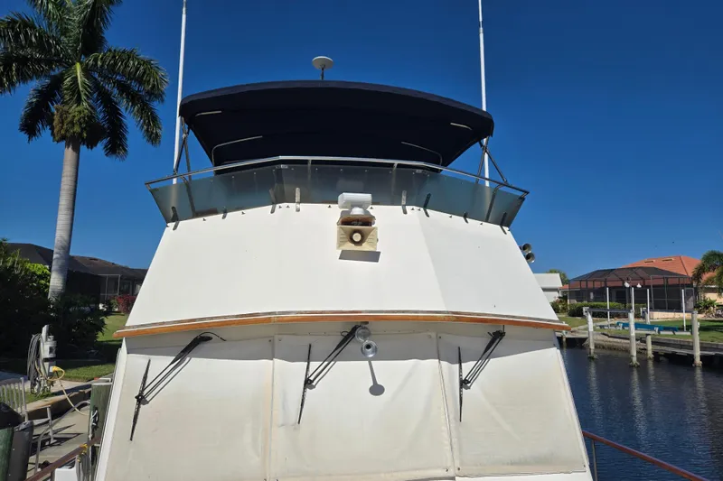 Slide: The Image of 1992 Grand Banks 46 Classic yacht docked by a canal under clear blue skies. - 91
