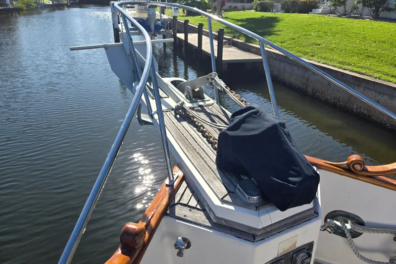 Slide: The Image of Bow of 1992 Grand Banks 46 Classic yacht with anchor chain and railing. - 92