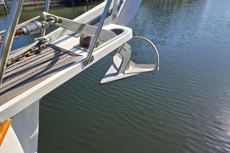 Slide: The Image of Anchor on a 1992 Grand Banks 46 Classic yacht over calm water. - 94