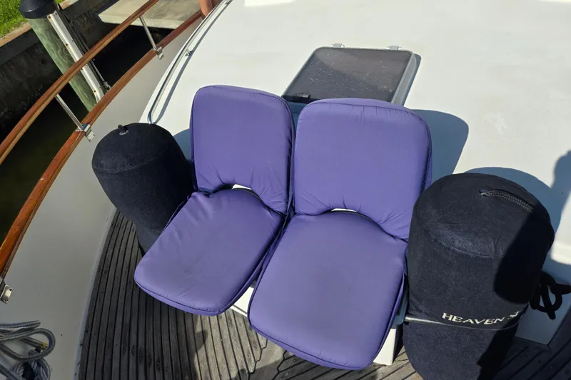 Slide: The Image of Two purple cushions on a 1992 Grand Banks 46 Classic yacht deck. - 97