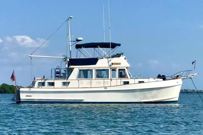 Slide: The Image of 1992 Grand Banks 46 Classic yacht anchored on calm blue waters under a clear sky. - 98