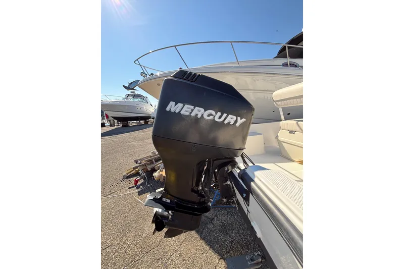 Slide: The Image of 2006 Mako 171 Center Console with Mercury outboard motor in a sunny marina setting. - 10