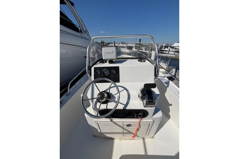 Slide: The Image of 2006 Mako 171 Center Console boat with Garmin navigation, docked at marina. - 2