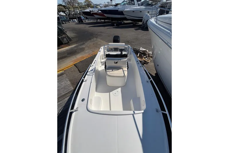 Slide: The Image of 2006 Mako 171 Center Console boat docked, showcasing spacious deck and seating area. - 3