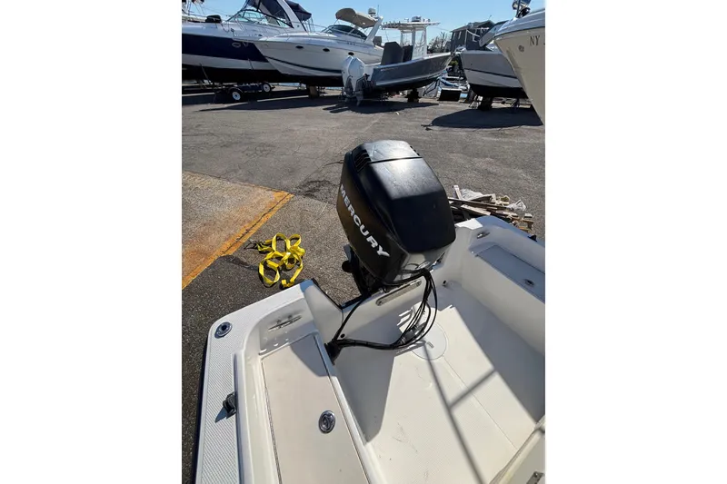 Slide: The Image of 2006 Mako 171 Center Console boat with Mercury outboard motor in a marina. - 5