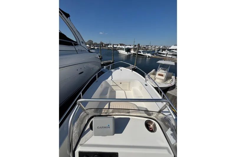 Slide: The Image of 2006 Mako 171 Center Console boat docked at marina, clear blue sky. - 7
