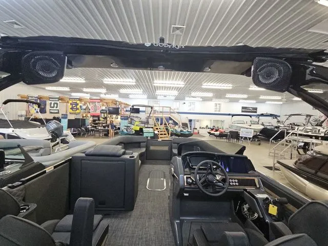 Slide: The Image of Interior view of 2026 Godfrey Sanpan 2500 SBC pontoon boat in showroom. - 11
