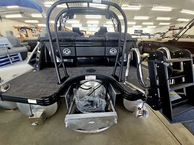Slide: The Image of Rear view of a 2026 Godfrey Sanpan 2500 SBC pontoon boat in showroom. - 6