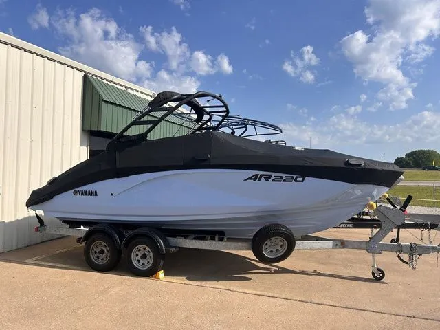 Slide: The Image of 2024 Yamaha AR220 boat on trailer, parked outdoors. - 23