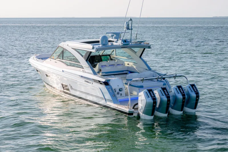 Slide: The Image of 2025 Formula 430 Super Sport Crossover boat on open water, featuring four powerful outboard engines. - 102