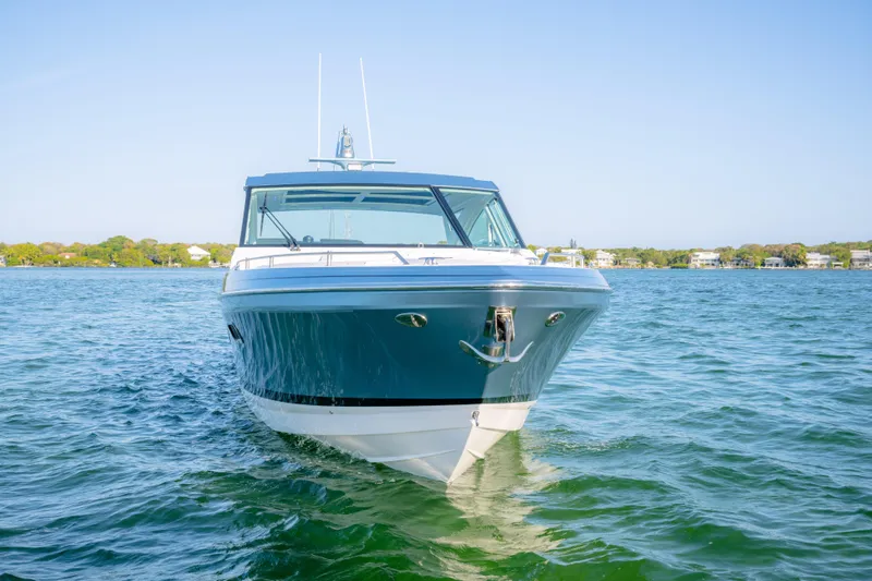 Slide: The Image of 2025 Formula 430 Super Sport Crossover boat on calm water, front view. - 104