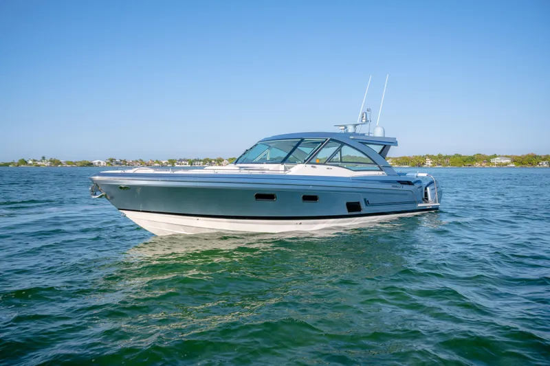 Slide: The Image of 2025 Formula 430 Super Sport Crossover boat cruising on clear blue water. - 105
