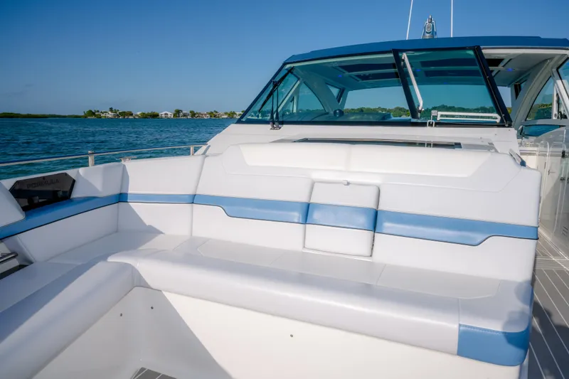 Slide: The Image of 2025 Formula 430 Super Sport Crossover boat interior with blue and white seating, ocean view. - 14