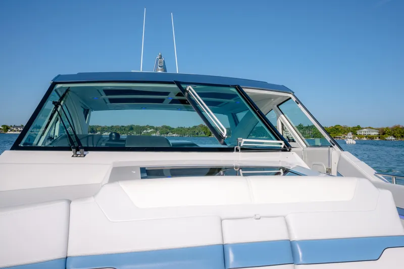 Slide: The Image of 2025 Formula 430 Super Sport Crossover boat on a sunny day, showcasing sleek design. - 15