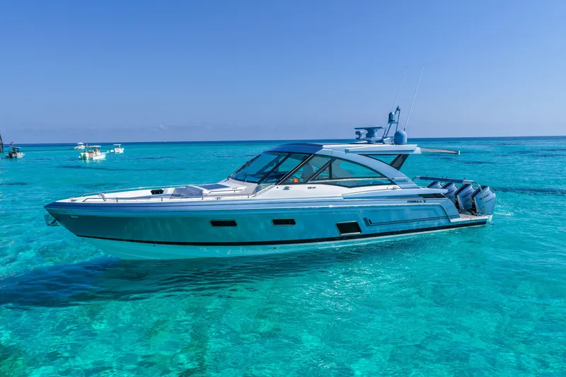 Slide: The Image of 2025 Formula 430 Super Sport Crossover yacht cruising in clear turquoise waters. - 3