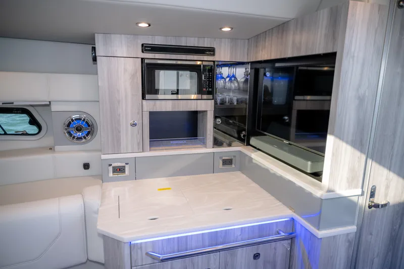 Slide: The Image of 2025 Formula 430 Super Sport Crossover interior with modern kitchenette and sleek design. - 43