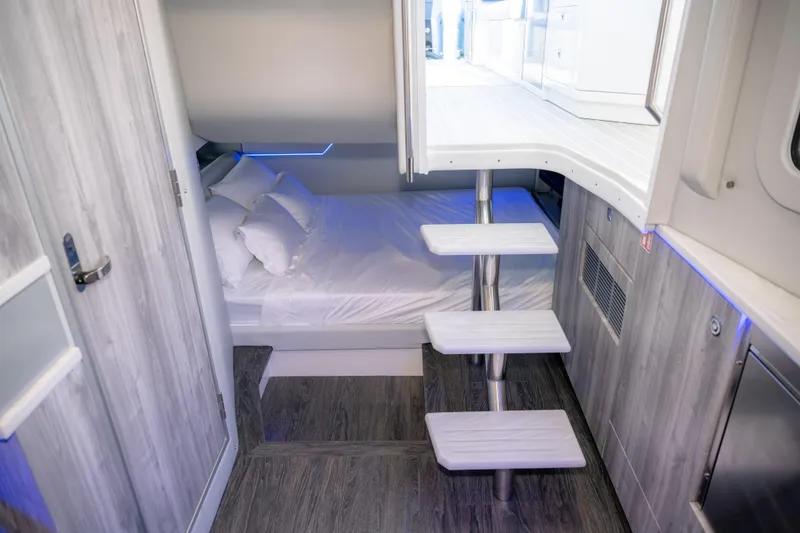 Slide: The Image of Interior of 2025 Formula 430 Super Sport Crossover, featuring modern cabin with bed and stairs. - 48