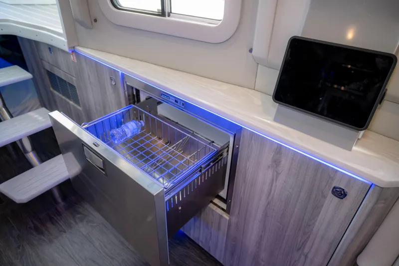 Slide: The Image of Interior of 2025 Formula 430 Super Sport Crossover with open drawer fridge and tablet. - 52