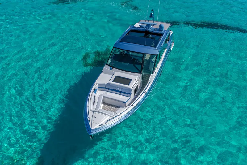 Slide: The Image of 2025 Formula 430 Super Sport Crossover cruising in clear turquoise waters. - 6