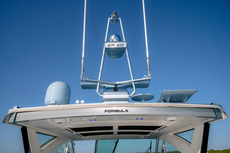 Slide: The Image of 2025 Formula 430 Super Sport Crossover boat with advanced radar equipment against clear blue sky. - 63