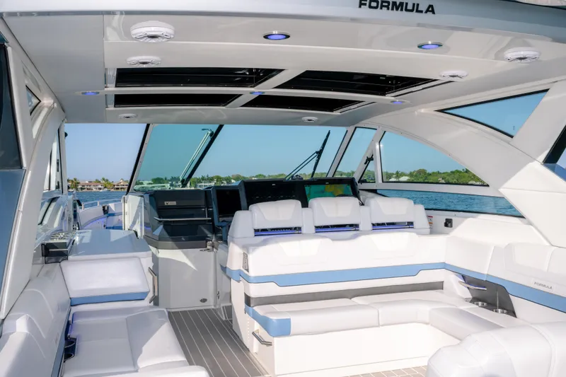 Slide: The Image of Luxurious interior of 2025 Formula 430 Super Sport Crossover yacht with modern seating and navigation. - 64