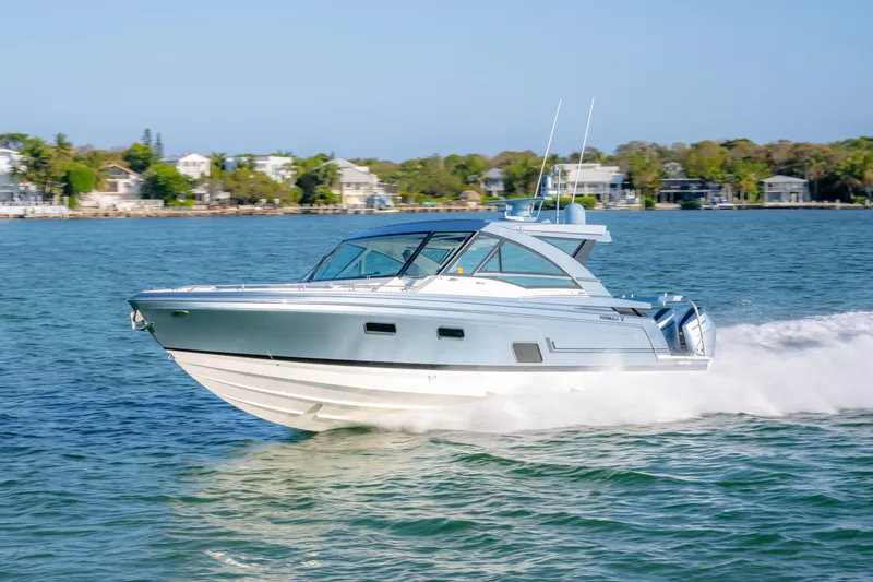 Slide: The Image of 2025 Formula 430 Super Sport Crossover cruising on a sunny day near coastal homes. - 74
