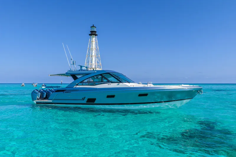 Slide: The Image of 2025 Formula 430 Super Sport Crossover yacht on clear turquoise water near a lighthouse. - 8