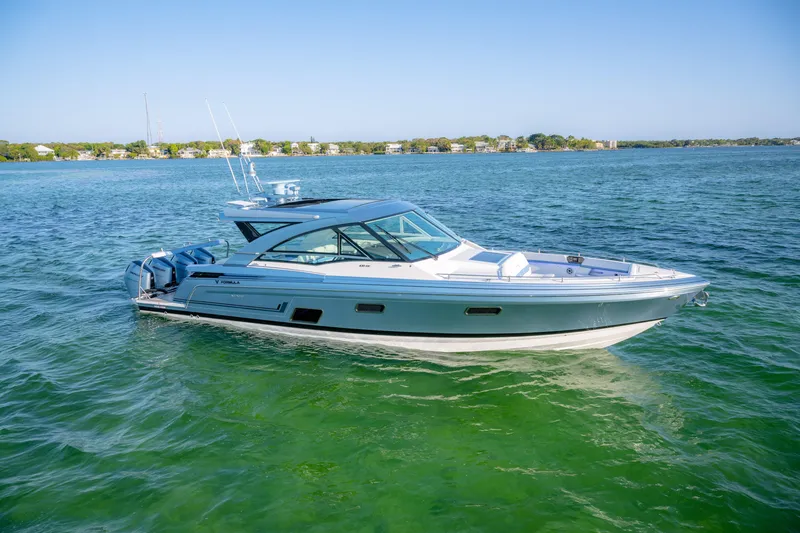 Slide: The Image of 2025 Formula 430 Super Sport Crossover boat cruising on clear blue water. - 83