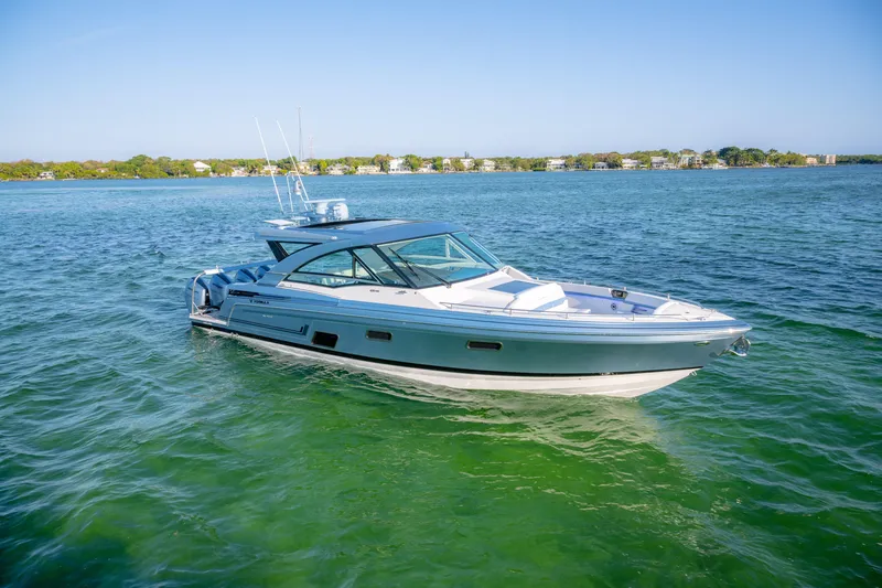 Slide: The Image of 2025 Formula 430 Super Sport Crossover boat cruising on clear blue water. - 84