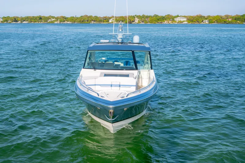 Slide: The Image of 2025 Formula 430 Super Sport Crossover boat cruising on clear blue water. - 87