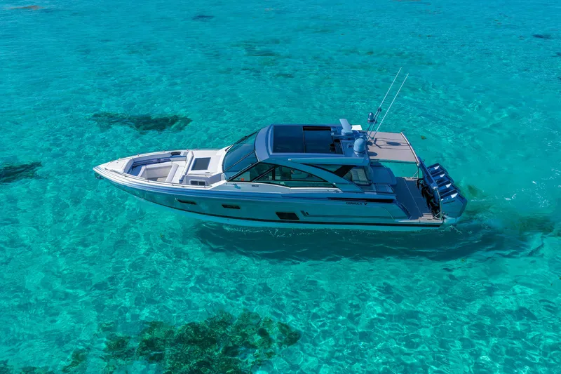 Slide: The Image of 2025 Formula 430 Super Sport Crossover cruising in clear turquoise waters. - 9