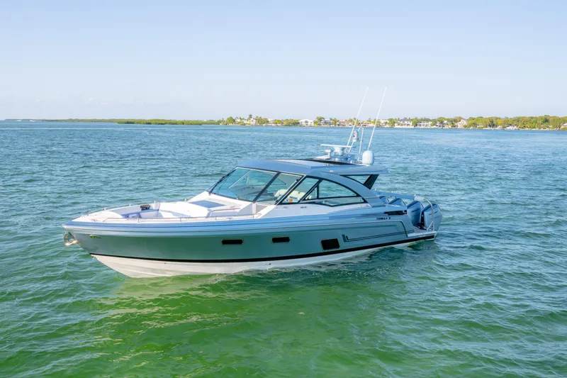 Slide: The Image of 2025 Formula 430 Super Sport Crossover boat cruising on clear blue water. - 92