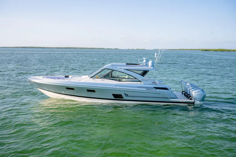 Slide: The Image of 2025 Formula 430 Super Sport Crossover cruising on open water under clear skies. - 98
