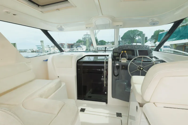 Slide: The Image of 2004 Tiara Yachts 3600 Sovran helm with luxurious seating and modern controls. - 11